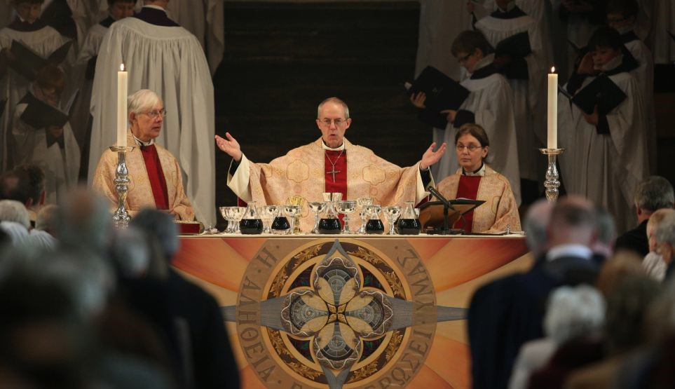 Catholics raising hands during the Our Father at Mass
